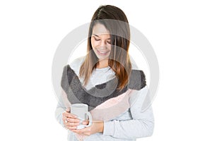 Woman pretty young relaxing looking down holding coffee cup or mug tea