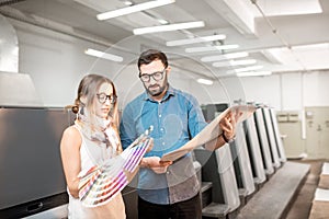 Woman with print operator at the manufacturing