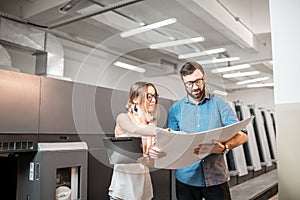 Woman with print operator at the manufacturing