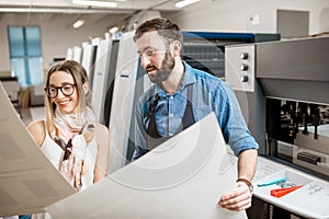 Woman with print operator at the printing manufacturing