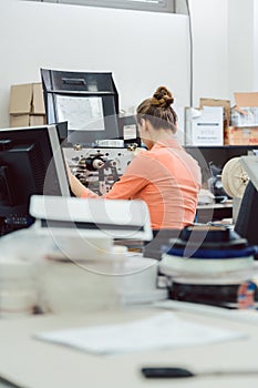 Woman in printing shop on the design computer