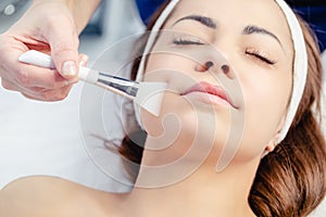Woman on procedure in cosmetological clinic