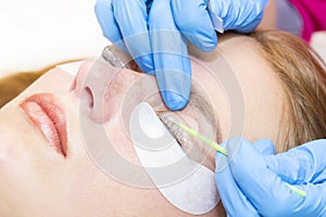 Woman on the procedure for eyelash extensions,