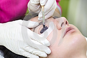 Woman on the procedure for eyelash extensions,