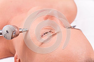 Woman while procedure jet peeling, facial treatmen