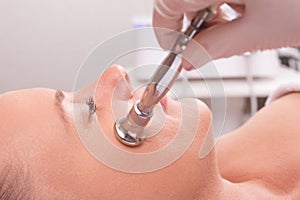 Woman while procedure jet peeling, facial treatmen