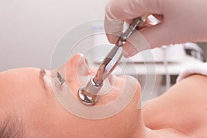 Woman while procedure jet peeling, facial treatmen