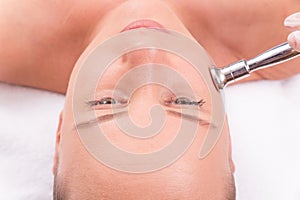 Woman while procedure jet peeling, facial treatmen