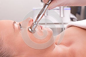 Woman while procedure jet peeling, facial treatmen