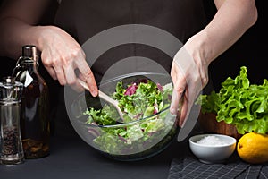 The woman in the process of making vegetable salad. Healthy Eating. Diet Concept. A Healthy Way Of Life. Cook At Home