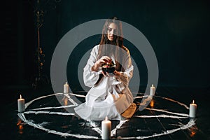 Woman produces a ritual of black magic, occultism