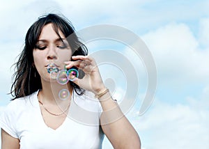 Woman produces soap bubbles