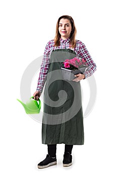 Woman professional gardener or florist in apron holding flowers in a pot and gardening tools isolated on white background. Copy s