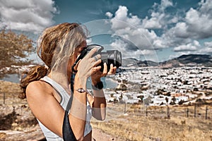 Woman is a professional photographer with dslr camera