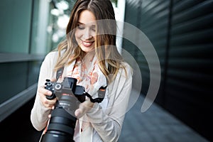 Woman is a professional photographer with dslr camera, outdoor and sunlight