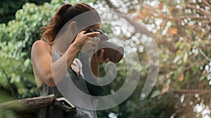 Woman is a professional photographer with dslr camera, soft focus, natural bokeh