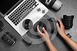 Woman with professional photographer equipment and laptop