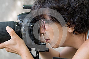 Woman is a professional photographer with slr camera