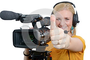 Woman with professional video camera,showing thumbs up