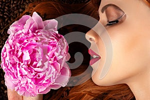 Woman profile face with peony on coffee beans