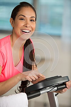 Woman programming exercise machine at home