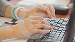 Woman is programming, woman is working on computer, female hands on keyboard close-up