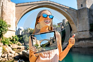 Woman promoting tourism in Mostar city