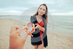 Woman Proposing to Her Beloved Partner at the Beach photo
