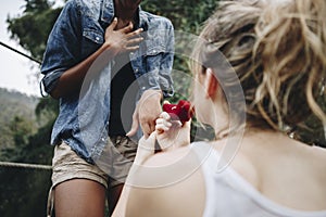 Woman proposing to her happy girlfriend outdoors love and marriage concept