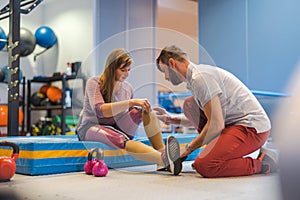 Woman with prosthetic legs talking to a physiotherapist