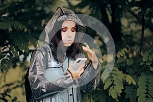 Woman Protecting Her Phone from Heavy Rain Fall