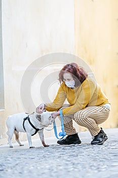 Woman with protective mask and dog