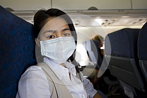 Woman with protective mask in a plane