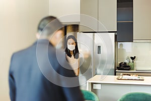 Woman in protective mask video call on cell phone with male real estate agent.