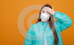 woman in protective medical equipment with medical mask on face on  yellow background, symptom of illness, coronavirus pandemic,