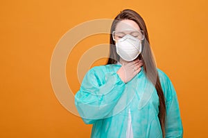 woman in protective medical equipment with medical mask on face on  yellow background, symptom of illness, coronavirus pandemic,