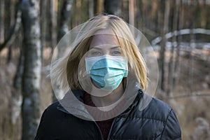 Woman in protective sterile medical mask on her face