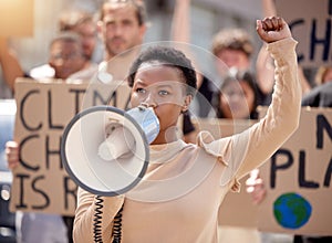 Woman, protest and megaphone with group for climate change support, global warming or crowd. Female person, fist and