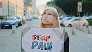 Woman protesting to stop pain by holding steamer