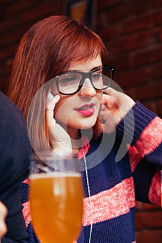 Woman In Pub Using Phone