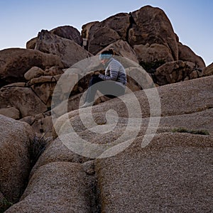 Woman In Puffy Coat Playing On Phone While Waiting for Sunrise