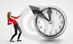 Woman pulling clock hands backwards