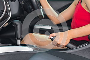 Woman pulling the hand brake