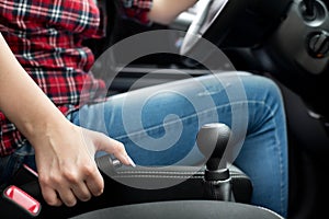 Woman pulling handbrake lever