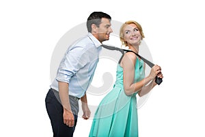 Woman pulling man for his tie