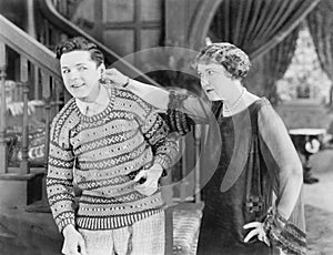 Woman pulling a man's ear