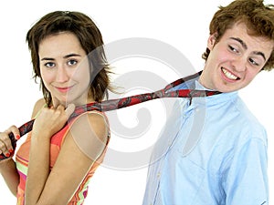 Woman pulling on man's tie