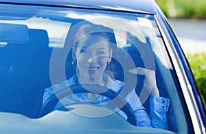 Woman pulling on seatbelt inside black car