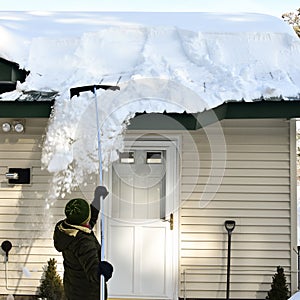 Woman pulling snow off of roof with snow rake