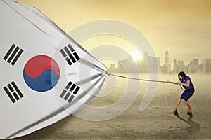 Woman pulling a south korean flag